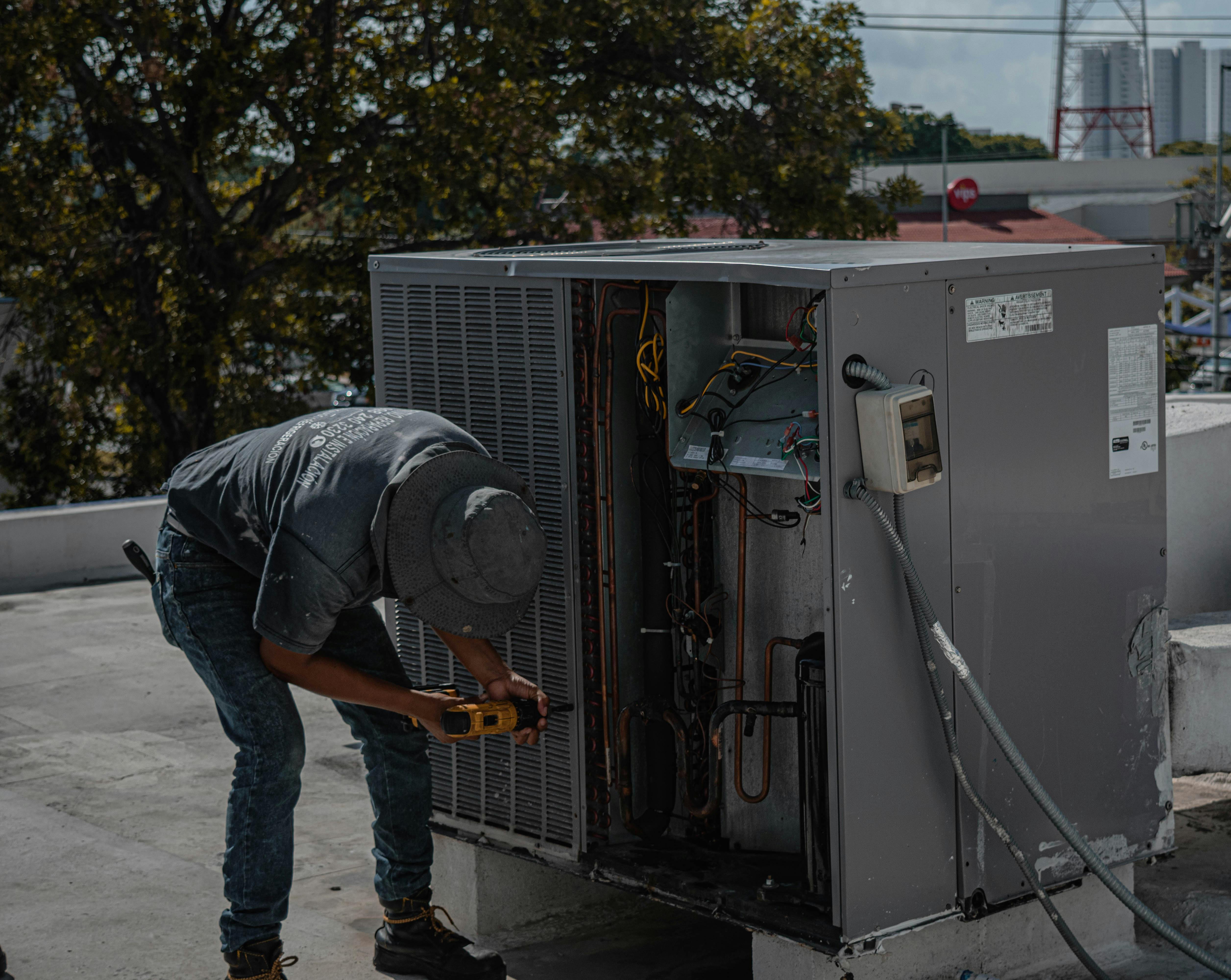 HVAC technician working on unit